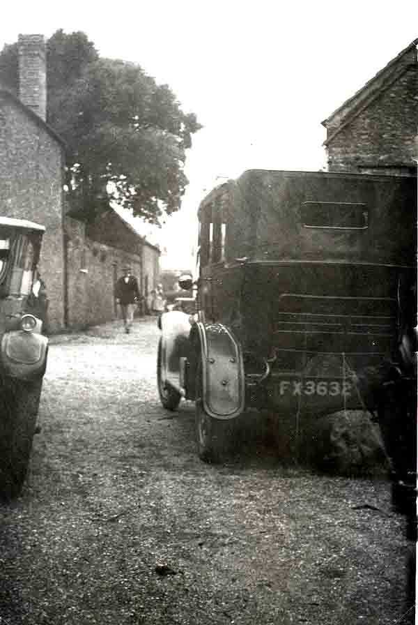Two old cars in a lane
