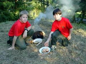 Ben and David cooking lamb chops in a mud Oven.